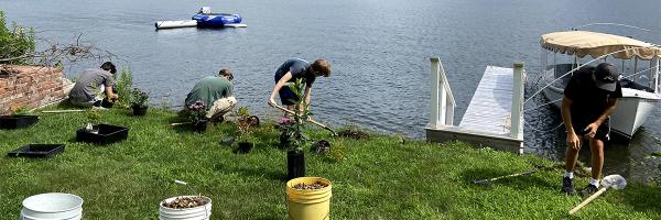 Photo courtesy of Hilary Solomon of Poultney Mettowee Natural Resource Conservation District Four young people plant native species on residential property near lakeshore